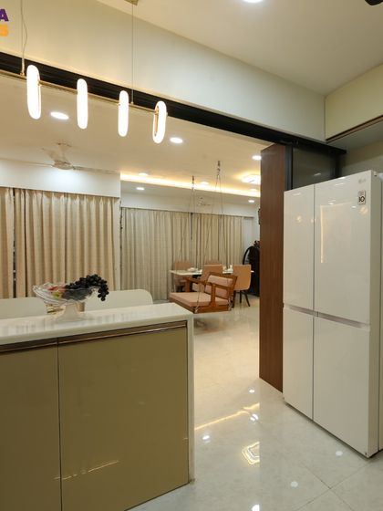 This shot shows the seamless integration of the refrigerator into the kitchen cabinetry and the open connection to the dining area.