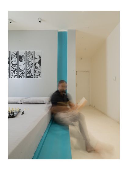 This shot captures the dynamic feel of the kid's bedroom, where a teal accent extends from the wall to the floor. The motion blur adds a sense of life and playfulness to this contemporary, superhero-themed space.