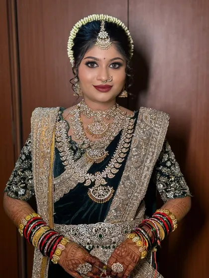A portrait of the bride in her black and gold Nauvari, showcasing her dramatic makeup.