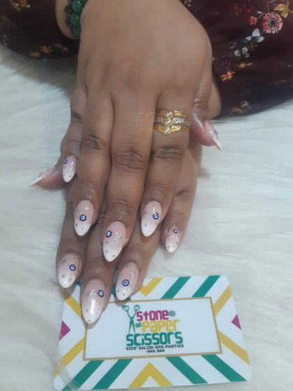 A protective and stylish set featuring hand-painted evil eye symbols on a white ombre base with delicate dots. This is a super popular and meaningful design choice.