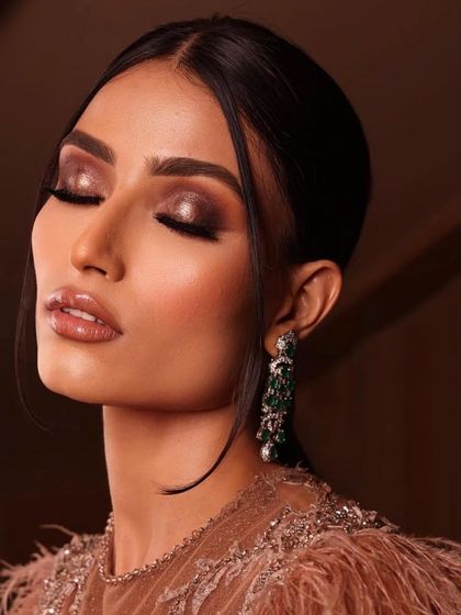 The same bronze smokey eye look, with a focus on the flawless skin and the sculpted cheekbones.