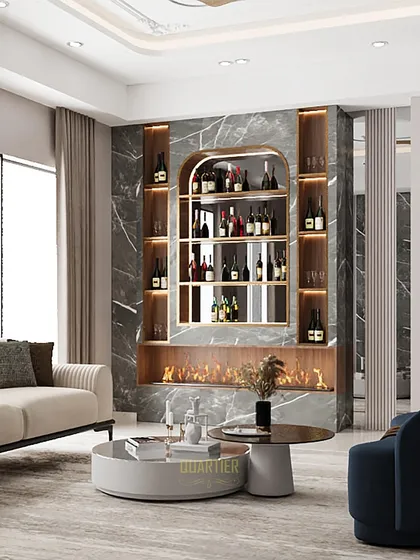This living area at Apex D'Rio features a stunning bar and fireplace unit as a focal point. The dark marble, combined with warm backlighting and a modern fireplace, creates a cozy yet dramatic atmosphere for entertaining.