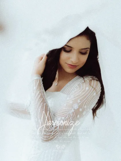 A soft, romantic close-up of the bride, her face gently framed by her veil. This intimate portrait captures the delicate beauty and emotion of the wedding day.