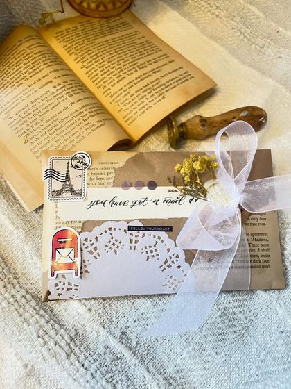 A flat-lay of a finished custom letter, showing off the 'you have got a mail' calligraphy and the little postal-themed stickers. It’s all about creating that perfect, Pinteresty aesthetic.
