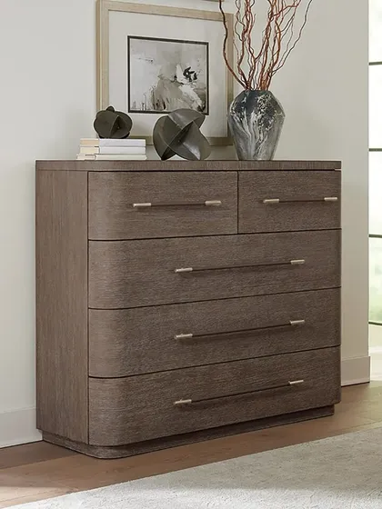 Softly sophisticated, this modern bachelor's chest features rounded corners and a plinth base. Crafted from oak veneers, it offers five self-closing drawers with the top two felt-lined and the bottom one cedar-lined.