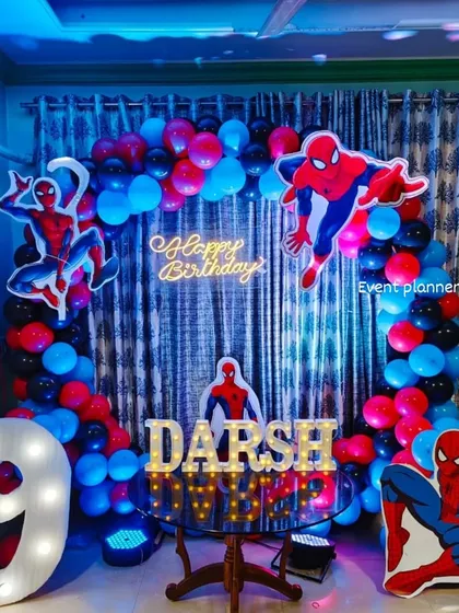 A close-up of the Spiderman 9th birthday decor, showing the marquee letters and neon sign.