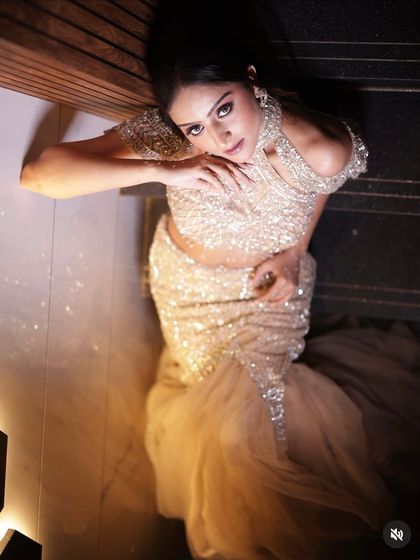 An artistic top-down shot showing the full sweep of the gown's mermaid tail and its sparkling details.