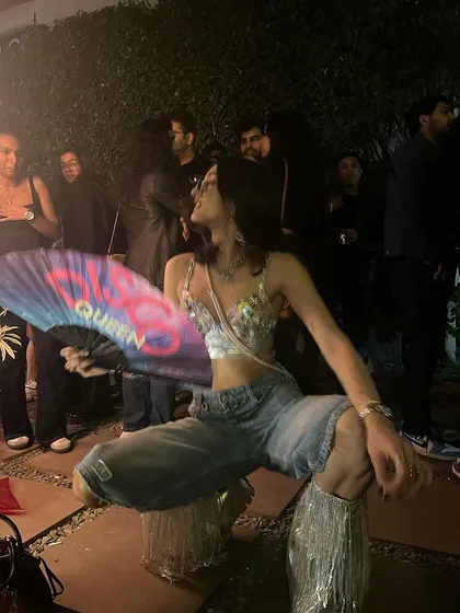 A moment of pure joy during my set. My custom outfit, the fan, the glitter, the energy from the crowd, it all comes together to create the ParaDisco experience.