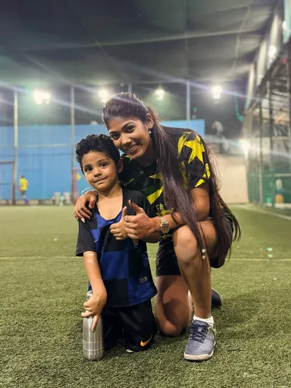 "Happiness is teaching someone something new everyday." Coach Shruti shares a happy moment with a young player, capturing the joy of coaching.