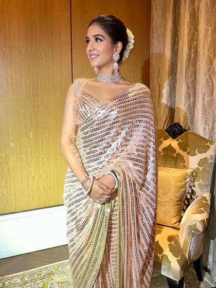 The full festive look. The shimmering sari and radiant makeup create a look of pure elegance and grace, perfect for celebrating Ganesh Utsav.