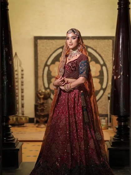 A full-length shot showing the bride in her complete regal attire. The makeup stands out, tying the entire look together.