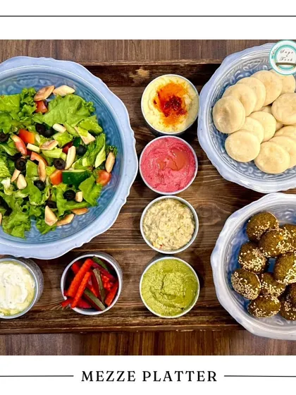 The Mezze Platter is a fantastic choice for a light and flavorful Rakhi celebration. It's packed with fresh salads, multiple dips, falafel, and pita, making it a healthy and shareable treat.