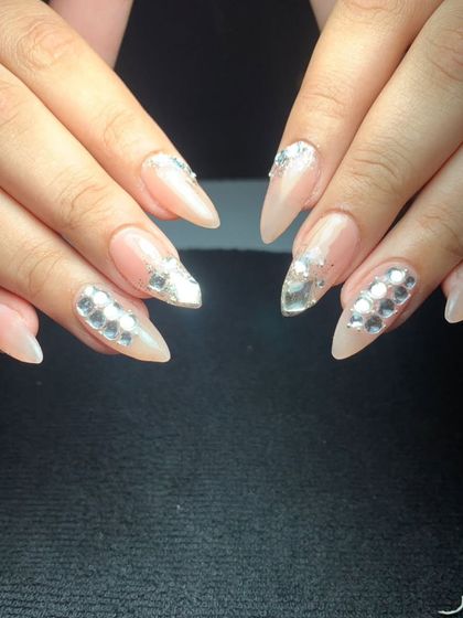 For the bride who loves sparkle, these stiletto nails are covered in reflective silver crystals. This design ensures your hands will glitter from every angle.