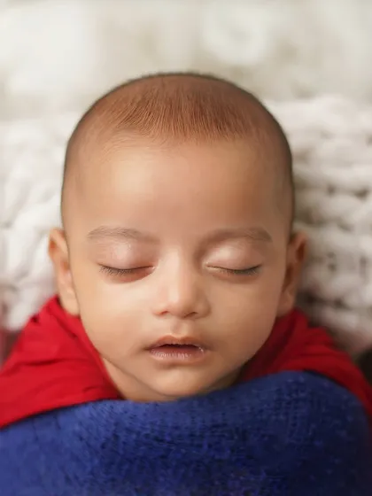 A close-up of the sleeping superhero. Even without the props, the red cape and blue wrap are instantly recognizable.