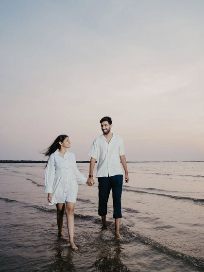 A quiet walk in the water as the sun sets. The soft, fading light creates a beautifully romantic and peaceful atmosphere.
