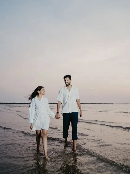 A quiet walk in the water as the sun sets. The soft, fading light creates a beautifully romantic and peaceful atmosphere.
