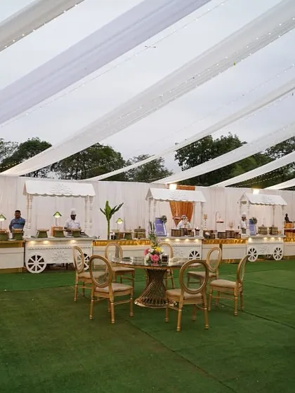 A full view of the outdoor catering area, showing how the food carts and seating are integrated seamlessly into the overall event design under a beautifully draped tent.