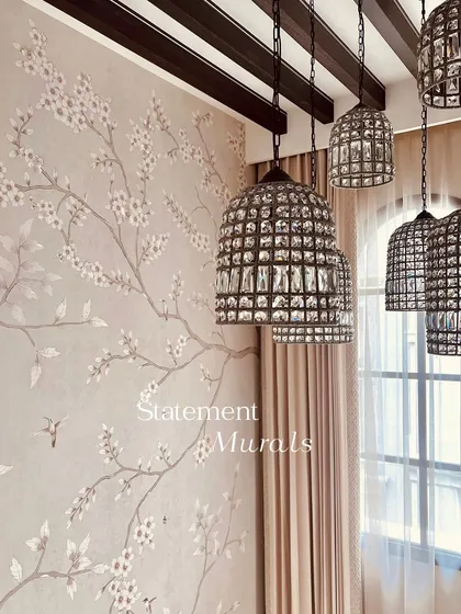 A statement mural featuring delicate cherry blossom branches. The soft, neutral background and gentle movement of the design add a sense of calm and elegance to this room.