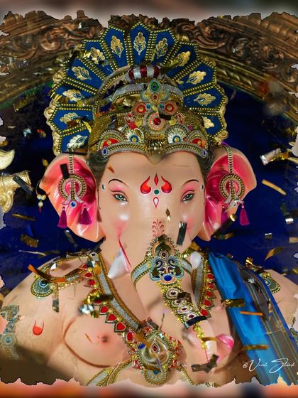 A frontal close-up of the Sanpada Cha Raja, with confetti adding to the festive feel.