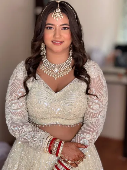 My bride Isha looking absolutely stunning for her wedding in an all-white lehenga. I created a soft, natural glam look to enhance her features.