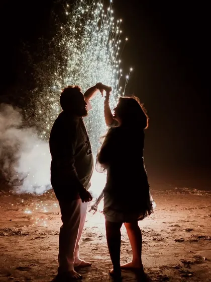A silhouette of a couple dancing under a shower of fireworks. This celebratory and dramatic shot is perfect for capturing the excitement and magic of your love story.