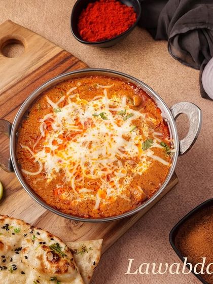 The Lawabdar Chicken is a rich and creamy main course. It's cooked in a flavourful gravy and topped with grated cheese, making it a truly indulgent dish.