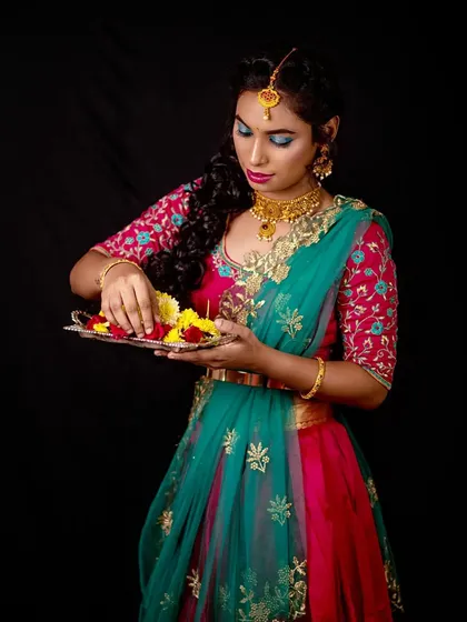 The final look for the festive shoot. The bright blue eyeshadow is paired with a pink and green lehenga for a colorful, celebratory feel.