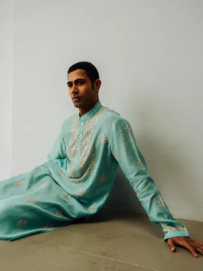 A relaxed pose for a Wabi Sabi lookbook. The soft blue of the kurta and the sprawling pose create a serene and contemporary feel for the ethnic menswear piece.