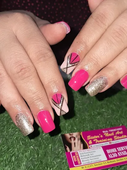 A still image of these bold pink and gold geometric nails.