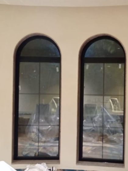 We can customize windows to any shape. Here are arched windows with a classic grid pattern, manufactured with precision to fit the architectural design.
