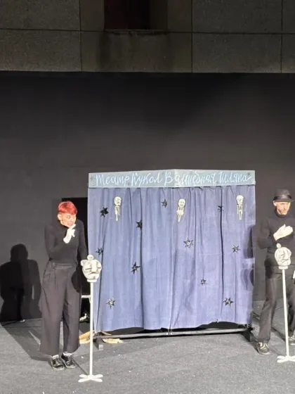 The full cast of puppeteers from 'Theatre in the Pocket' takes a bow. Their minimalist costumes ensure that all focus remains on the puppets they bring to life.