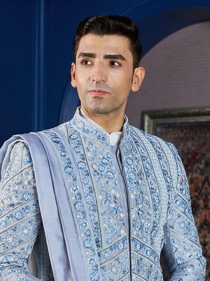 A close-up portrait showcasing the fine details of the embroidery and the elegant drape of the stole. The craftsmanship speaks for itself.