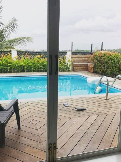 Looking out from the residence, this image shows how the terrace pool is framed as an extension of the living space. The sliding glass doors open directly onto the wooden deck, creating a seamless indoor-outdoor connection.