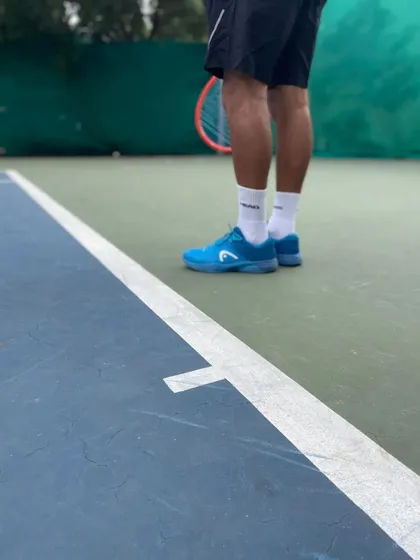 Footwork starts with the right footwear. This shot highlights the design of modern tennis shoes built for lateral movement and support on the baseline.