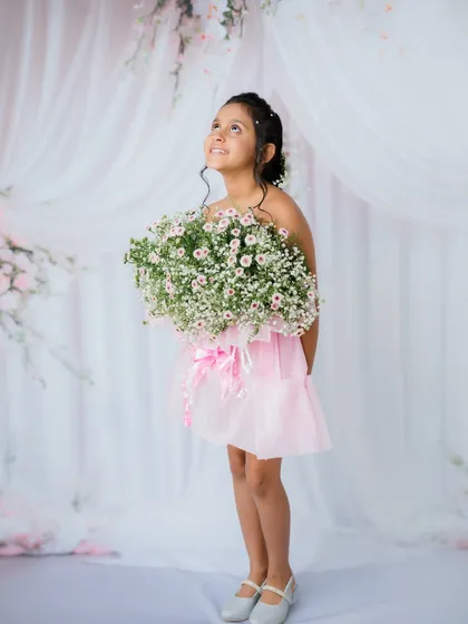 Looking up with a hopeful, dreamy expression. This pose adds a touch of magic to her portrait.
