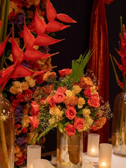 A close-up of one of the floral arrangements, featuring birds of paradise, roses, and other blooms in warm, fiery tones that matched the Diwali theme.