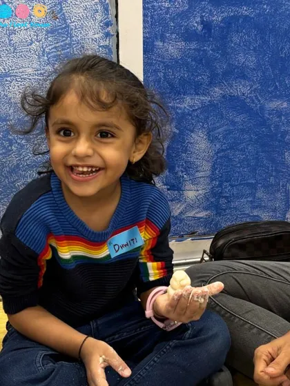 A happy smile from a young participant at our kids' club. Creating joyful experiences is what we do best.