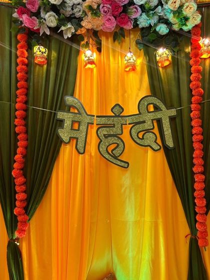 Setting the scene for a beautiful mehendi ceremony with traditional marigold and floral decor.