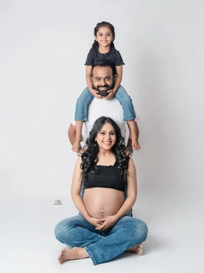 Let's have some fun. This playful "family totem pole" pose is a great way to get genuine smiles and create a memory that shows your family's fun-loving spirit.