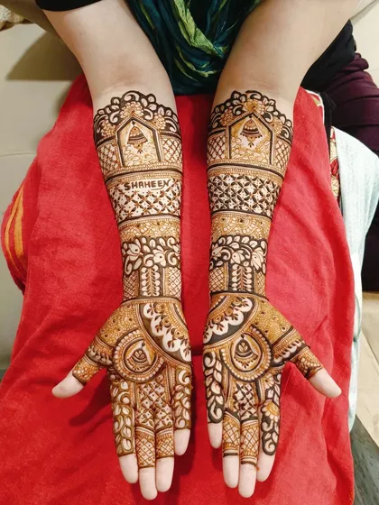 A full view of the client's intricate bridal mehndi.