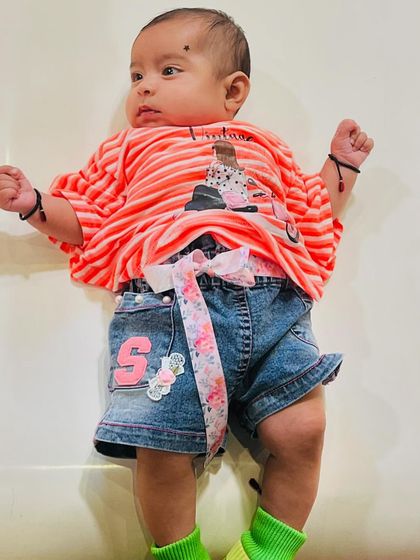 A close-up of our adorable little visitor, comfortable and safe as she enjoys the play area.