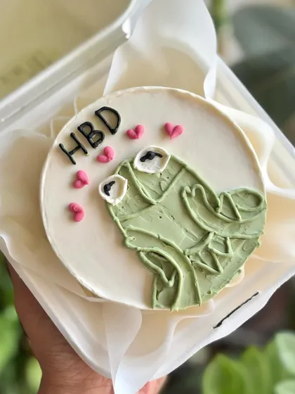 A top-down view of the Kermit the Frog meme bento, showing the cute heart details and "HBD" message.