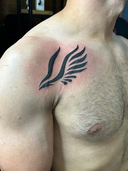 A side view of one of the cover-up wings, showing the clean, bold blackwork.