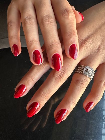 A classic, powerful red manicure. This timeless look is perfect for any occasion and never goes out of style.