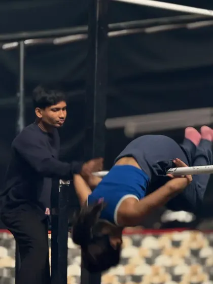 Safely guiding a student through a front roll on the bar. I make sure every member learns new skills with the right technique.