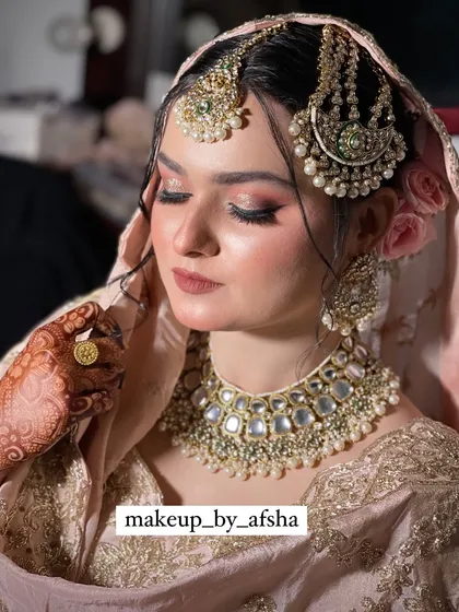 A close-up on her beautiful, soft makeup and the intricate jewellery.