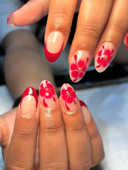 Another view of the blooming red floral nail art, showing the intricate details of the hand-painted petals.