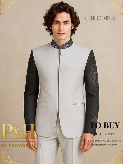 A variation in a lighter grey, this zipper Jodhpuri suit offers a softer but equally modern aesthetic, with detailed embroidery on the black sleeves and collar.