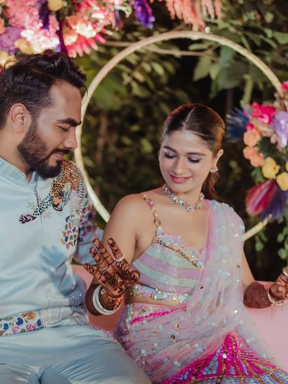 My bride Mansi looking chic and colorful for her carnival-themed mehendi event in a Papa Don't Preach saree.