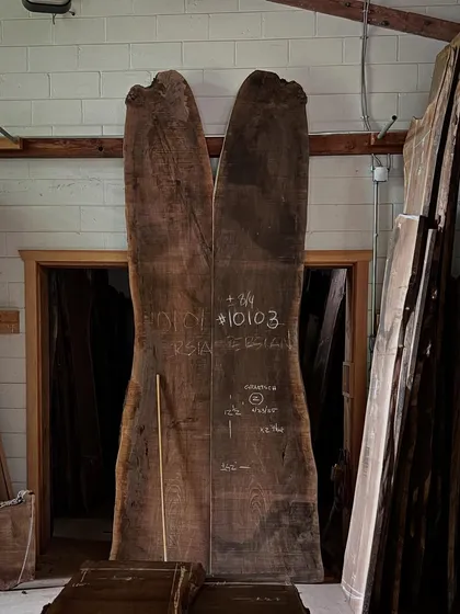Two massive, book-matched slabs of walnut stand ready in the Nakashima workshop. Each piece of wood has its own story and destiny, and it is the craftsman's job to reveal its soul.